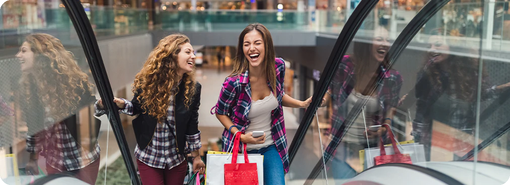 women in shopping mall using upside app